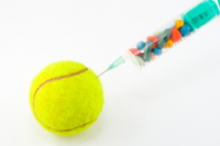 A syringe injecting colourful pretend drugs into a tennis ball