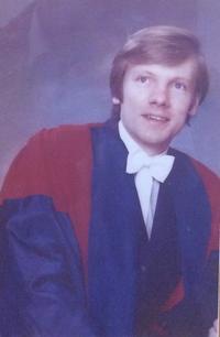 Image of Michael Lockwood Image of Michael Lockwood, posing for a formal photograph in subfusc, with a red and blue academic gown