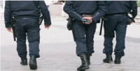 Military showing from the waist down three armed military personnel